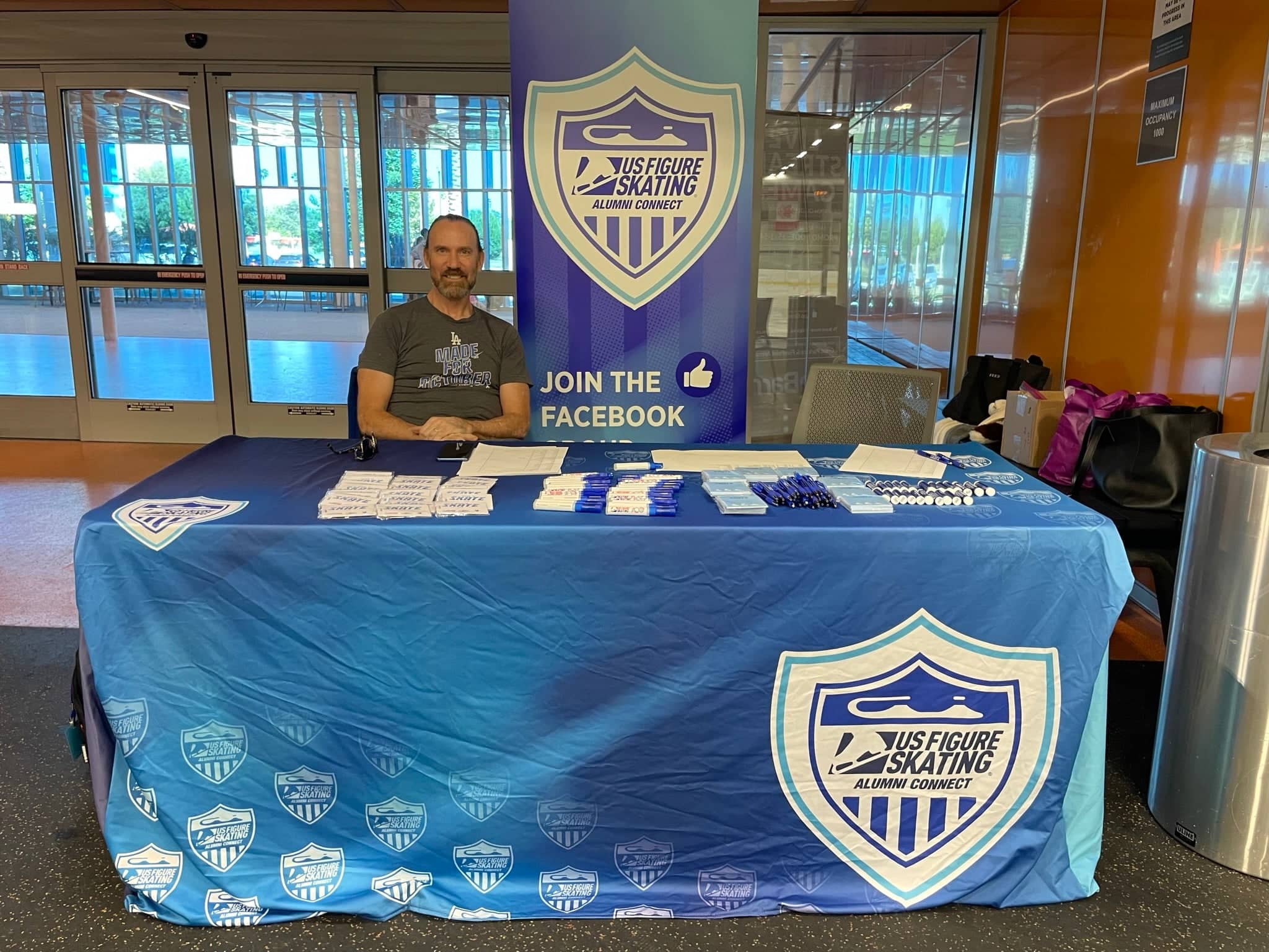 Doug Williams sits at the alumni connect check in table